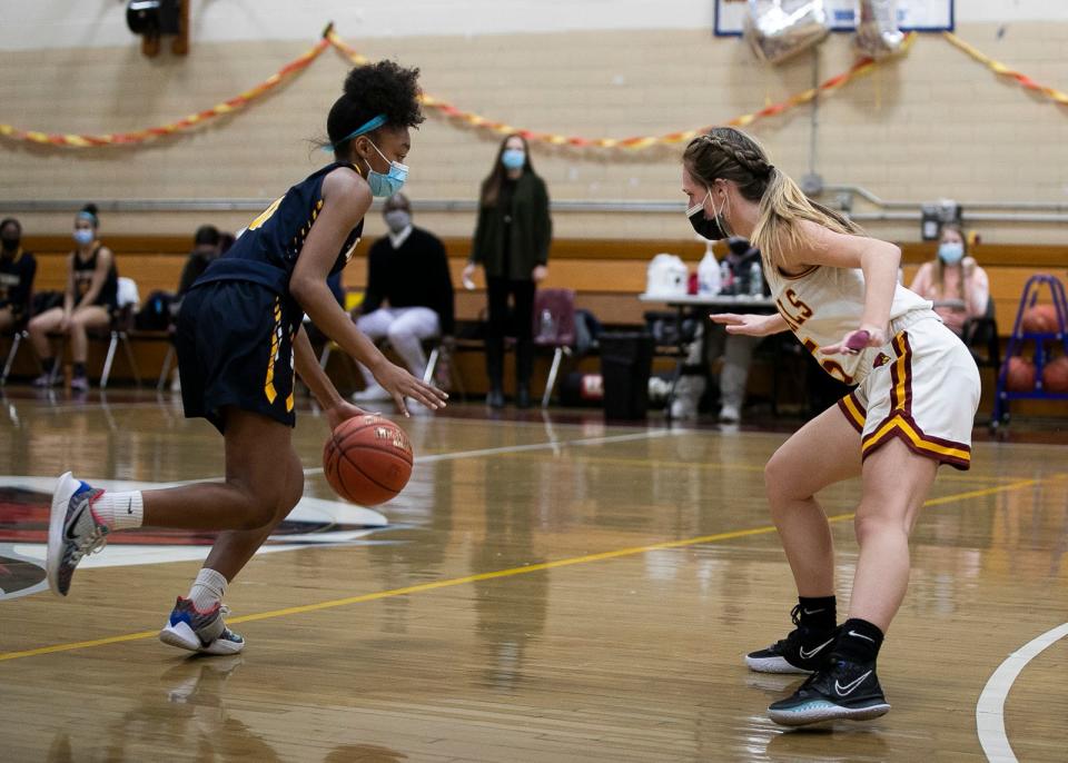 Fontbonne Academy’s Alix Abelard dribbles down the court as Cardinal Spellman’s  Alyssa Belmont puts pressure on her during the game on Monday, Feb. 8, 2021 at Cardinal Spellman High School in Brockton.