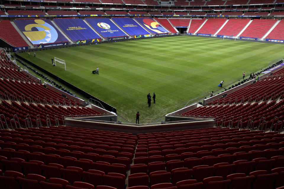 Employees prepare the National Stadium for the Copa America soccer tournament in Brasilia, Brazil, Friday, June 11, 2021. The stadium will host the opening game on June 13. (AP Photo/Eraldo Peres)