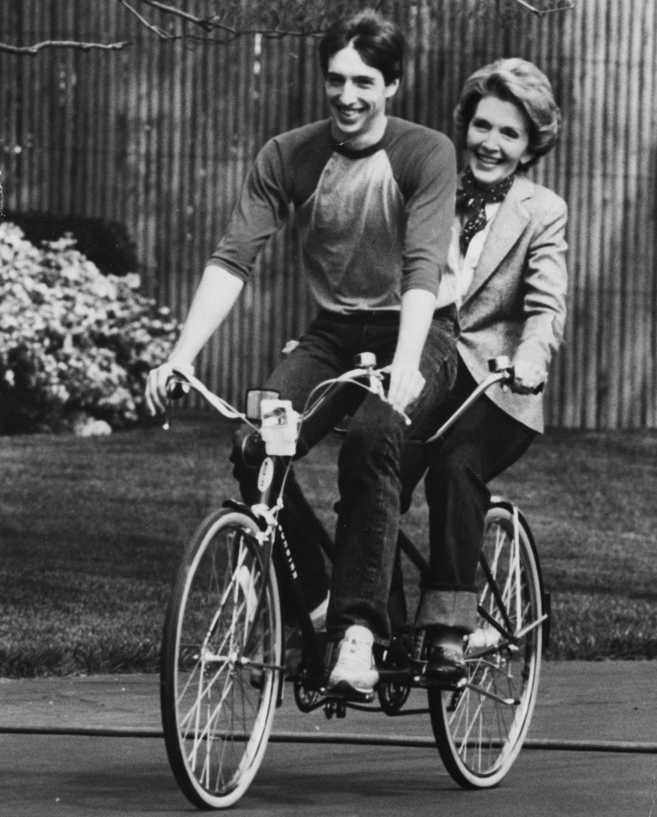 Ron Reagan riding a bike with mother first lady Nancy Reagan