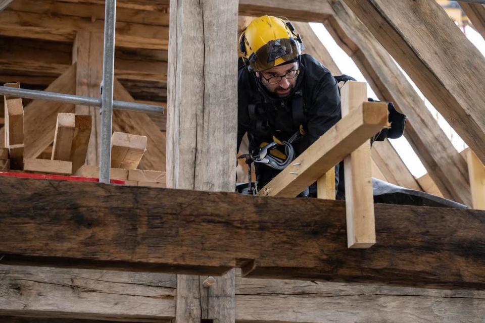 Hank Silver, a carpenter from Massachusetts, works on roof trusses for the nave of Paris' Notre Dame cathedral. / Credit: Courtesy of Hank Silver