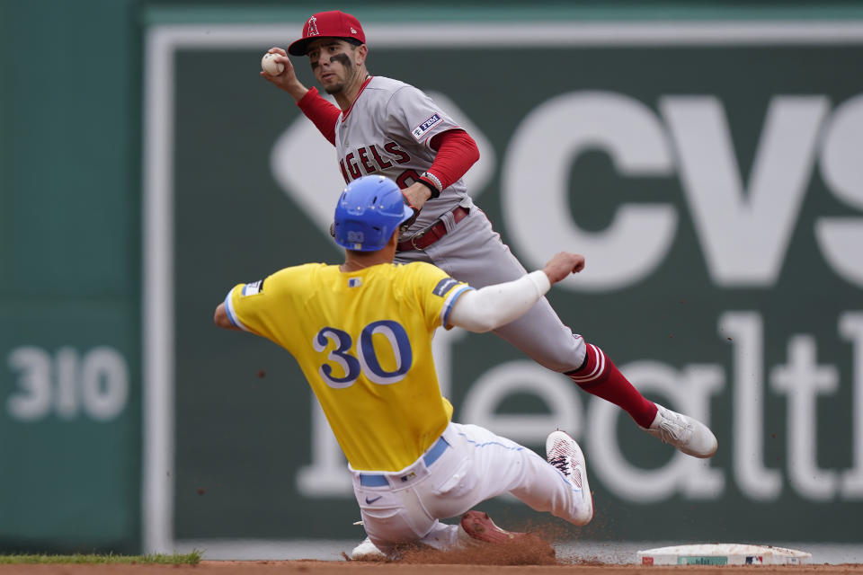 Los Angeles Angels' Zach Neto, top, throws to first base to complete a double play as Boston Red Sox's Rob Refsnyder (30) slides out at second in the sixth inning of a baseball game, Sunday, April 16, 2023, in Boston. (AP Photo/Steven Senne)