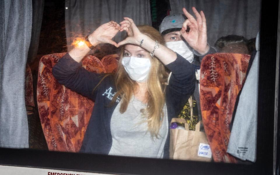 Passengers in coaches, that have been repatriated to the UK from the cruise ship hit by the coronavirus arrive at Arrowe Park Hospital on the Wirral, where they will be quarantined for 14 days  - PA 