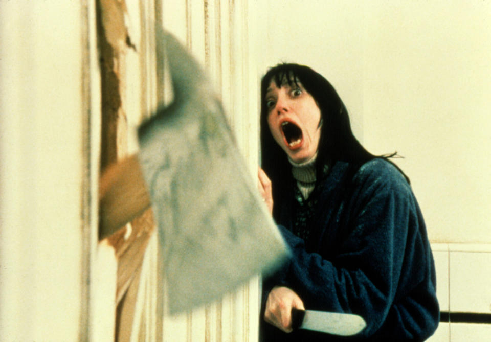 An axe coming through the wall and a woman screaming with a knife in her hands