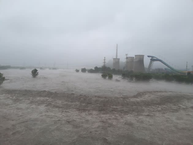 Flood waters run through the Shougang Bridge after the Yongding River was discharged in Beijing, August 1, 2023.