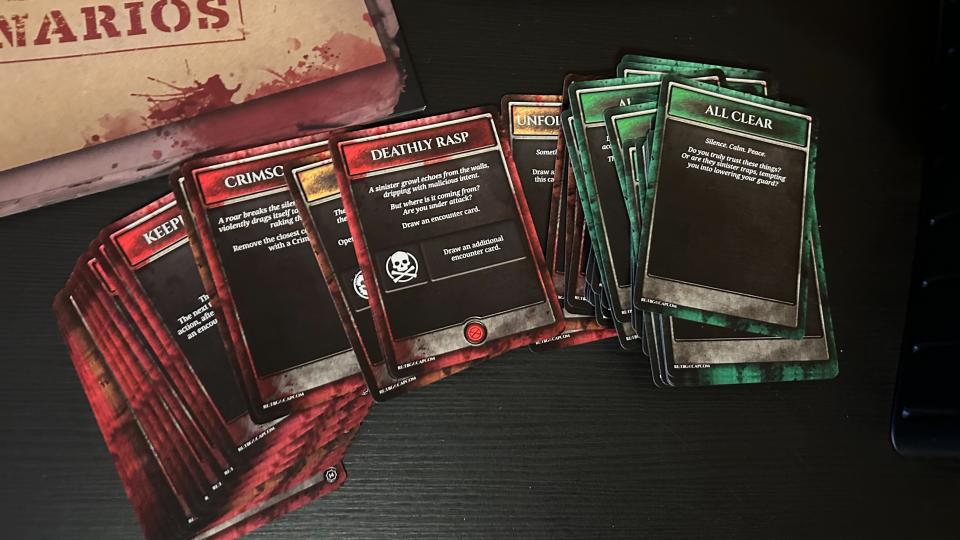 Resident Evil Tension Deck cards spread out on a black table