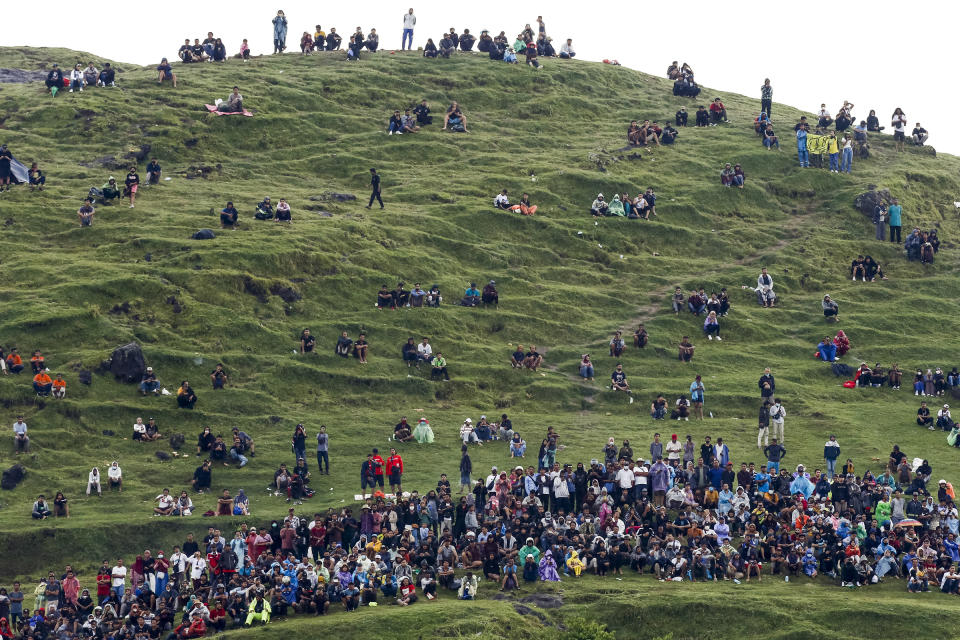 Spectators sit on a hill near the Mandalika International Street Circuit during a Grand Prix race on March 20, 2022.<span class="copyright">Johannes P. Christo—Anadolu Agency/Getty Images</span>