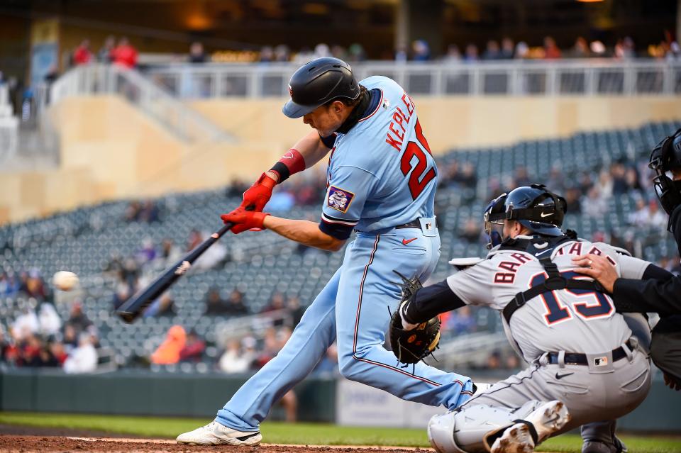 Twins right fielder Max Kepler hits an RBI double next to Tigers catcher Tucker Barnhart during the second inning on Tuesday, April 26, 2022, in Minneapolis.