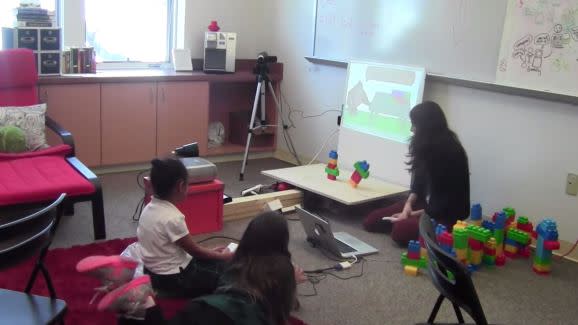 Kids using a Kinect-powered learning game about elementary physics.