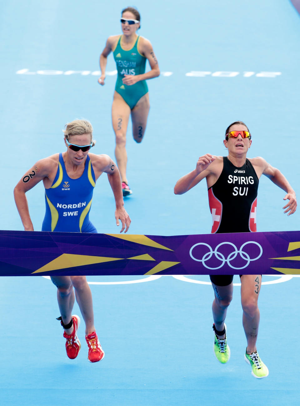 LONDON, ENGLAND - AUGUST 04: Lisa Norden of Sweden (L), Nicola Spirig of Switzerland (R), and Erin Densham of Australia finish the Women's Triathlon on Day 8 of the London 2012 Olympic Games at Hyde Park on August 4, 2012 in London, England. (Photo by Adam Pretty/Getty Images)