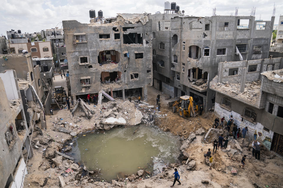 A crater full of water and sewage remains where the home of Ramez al-Masri was destroyed by an air-strike prior to a cease-fire reached after an 11-day war between Gaza's Hamas rulers and Israel, Sunday, May 23, 2021, in Beit Hanoun, the northern Gaza Strip. (AP Photo/John Minchillo)