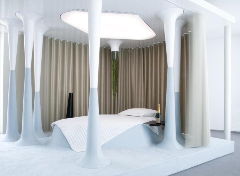 Designer of the Year Mathieu Lehanneur’s “Once Upon a Dream” smart sleep installation imagines a futuristic bedroom set inside a grove of modern columns and graced by a chandelier of greenery