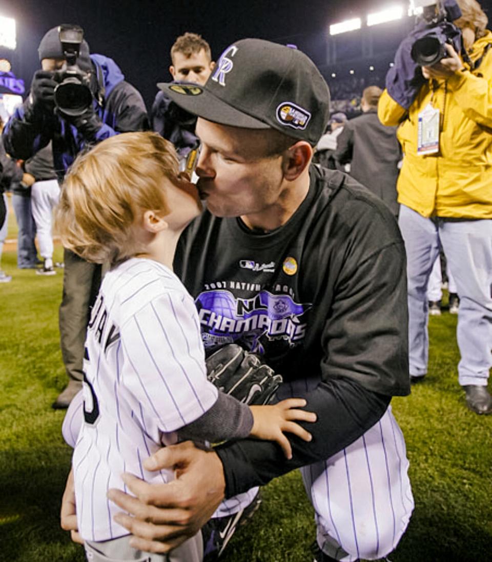 Matt Holliday kisses his son Jackson during the 2007 season in Colorado. Jackson is now one of the top baseball prospects in the country.