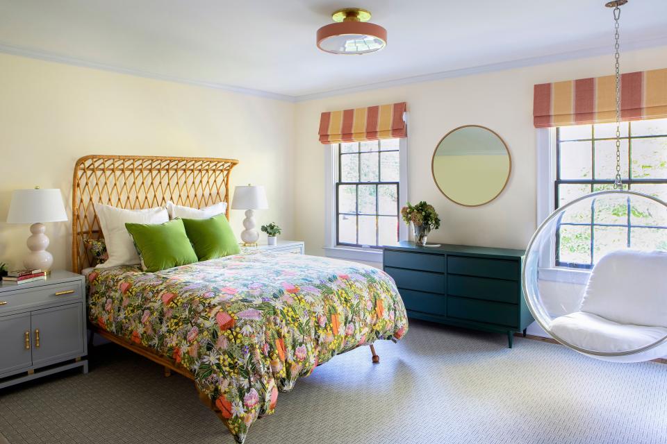The daughter’s room is centered around a curved rattan bed from Anthropologie. The hanging chair, by Thibaut, adds a youthful energy to the space. The night tables are by World’s Away, and the peacock green dresser is from Chairish. The Flushmount light, by The Urban Electric Company, is in a custom pink shade. The window coverings are by Malabar.