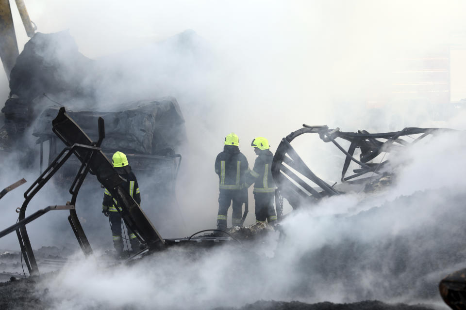 Firefighters work to extinguish burning fuel tankers in Kabul, Afghanistan, Sunday, May 2, 2021. A fire roared through several fuel tankers on the northern edge of the Afghan capital late Saturday, injuring at least 10 people and plunging much of the city into darkness, officials said. (AP Photo/Rahmat Gul)