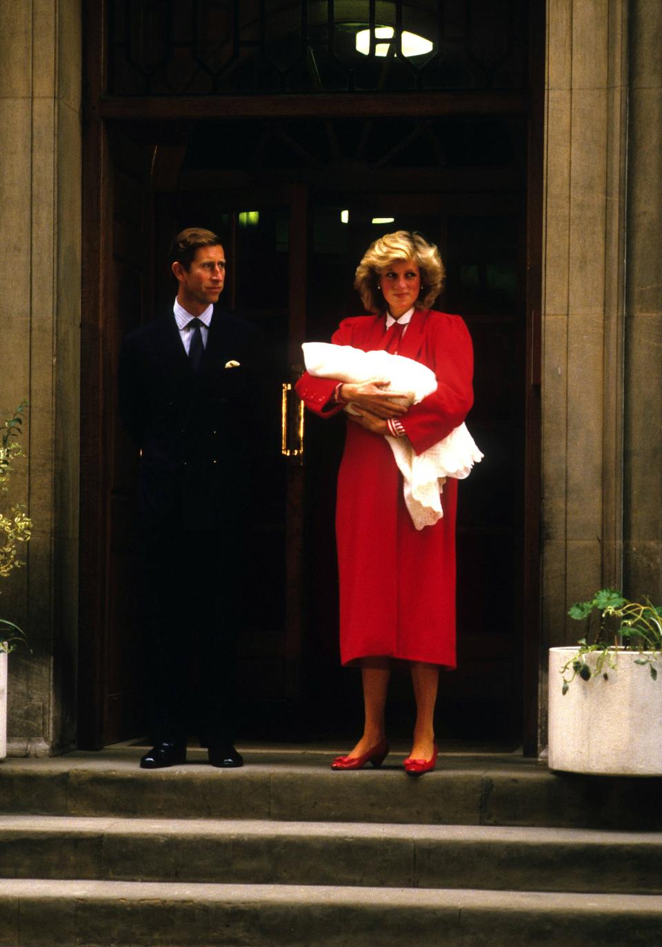 Prince Charles and Princess Diana present Prince Harry