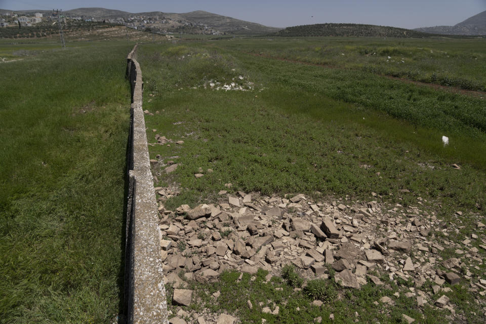 Stones cover the unmarked grave of Palestinian Zuhair al-Ghaleeth, 23, on the outskirts of the West Bank city of Nablus, Thursday, May 4, 2023. The killing of al-Ghaleeth last month, the first slaying of a suspected Israeli intelligence collaborator in the West Bank in nearly two decades, has laid bare the weakness of the Palestinian Authority and the strains that a recent surge in violence with Israel is beginning to exert within Palestinian communities. (AP Photo/Nasser Nasser)