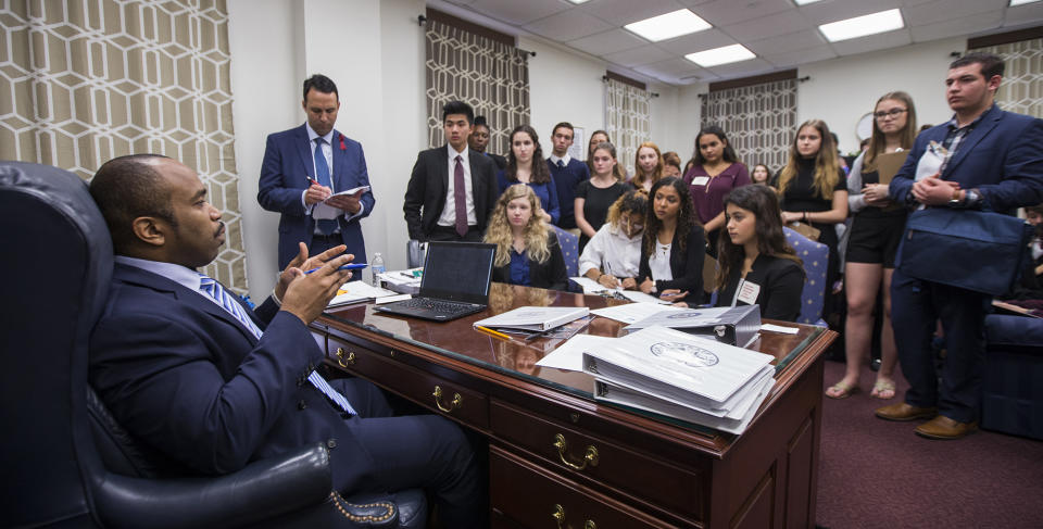 <p>Sen. Bobby Powell talks with survivors from Marjory Stoneman Douglas High School and other students from Broward County, Fla. high schools in his office at the Florida Capital in Tallahassee, Fla., Feb 20, 2018.Students from Marjory Stoneman Douglas High School,, where a shooting left 17 dead, are in Tallahassee channeling their anger and sadness into action. (Photo: Mark Wallheiser/AP) </p>