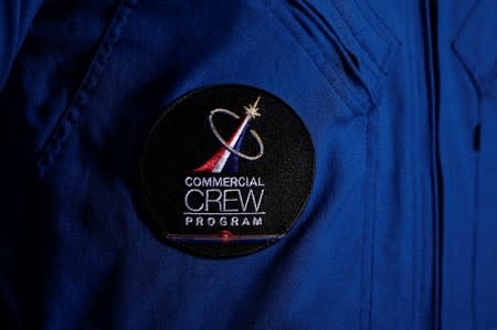 A NASA commercial Crew patch is worn by astronaut Bob Behnken at Johnson Space Center in Houston, Texas