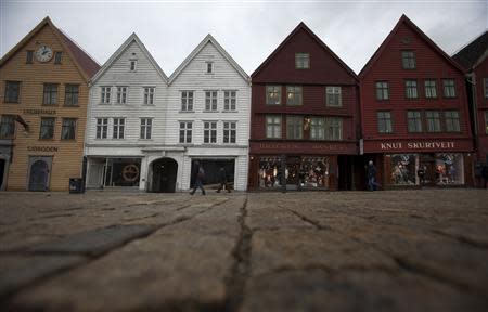 People walk near Bryggen (the Wharf) near the marina in downtown Bergen in this March 20, 2012 file photo. REUTERS/Stoyan Nenov/Files