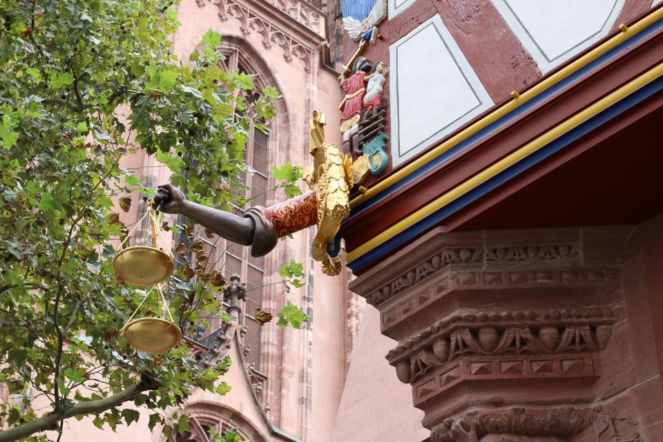 A replica of the golden scales which hang off the corner of the Haus zur Goldenen Waage.