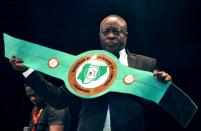 Boxing promoter Raufu Ladipo displays a lightweight belt to be contested by boxers during a GOtv title fight at the National Stadium in Lagos on April 15, 2018