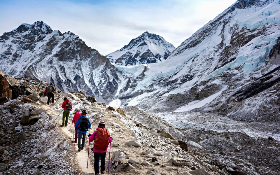 Hikers walk to Everest Base Camp during Everest Base Camp trekking in Nepal - Kriangkrai Thitimakorn/Getty Images