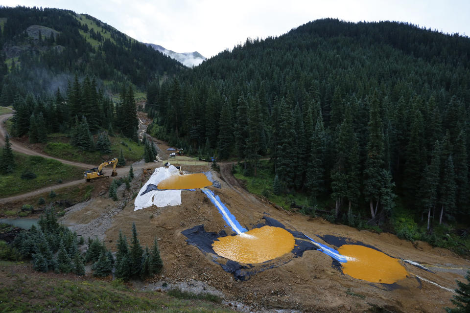 FILE - In this Aug. 12, 2015, file photo, water flows through a series of retention ponds built to contain and filter out heavy metals and chemicals from the Gold King mine accident outside Silverton, Colo. A federal appeals court Friday, July 19, 2019, has sided with the Trump administration after it was sued for dropping an Obama-era proposal that would have required mining companies to prove they have enough money to clean up their pollution. (AP Photo/Brennan Linsley, File)