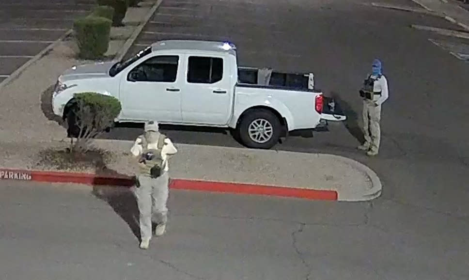 Armed individuals dressed in tactical gear at the site of a ballot drop box in Mesa, Ariz., on Oct. 21, 2022. (Maricopa County Elections Department  / AFP - Getty Images)