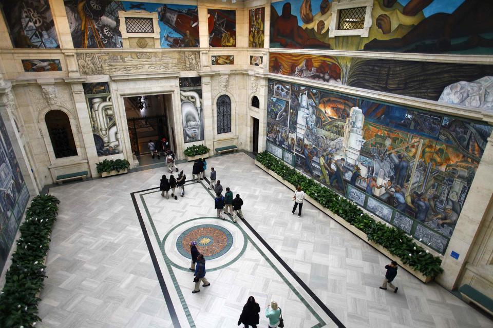 People look at a mural by artist Diego Rivera at the Art Institute of Detroit in Detroit