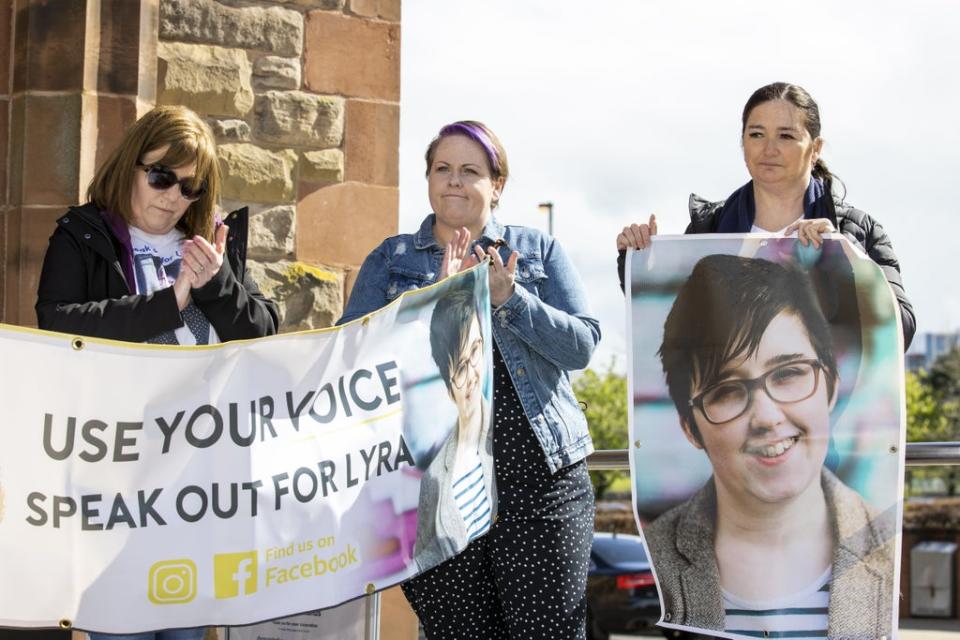 Lyra McKee’s sisters’ Nichola Corner (left) and Joan Hunter (right) stand with Ms McKee’s partner Sara Canning (centre) during a vigil attended by members of the National Union of Journalists (NUJ) at the Guildhall in Derry, to mark the third anniversary of Lyra McKee’s murder. (PA Wire)