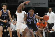 Miami forward Norchad Omier (15) defends Duke guard Jeremy Roach (3) during the first half of an NCAA college basketball game, Monday, Feb. 6, 2023, in Coral Gables, Fla. (AP Photo/Marta Lavandier)