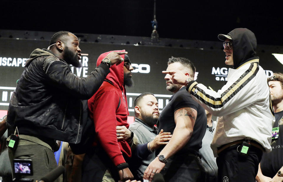 Deontay Wilder, left, and Tyson Fury face off for photographers during a news conference for their upcoming WBC heavyweight championship boxing match, Wednesday, Feb. 19, 2020, in Las Vegas. (AP Photo/Isaac Brekken)