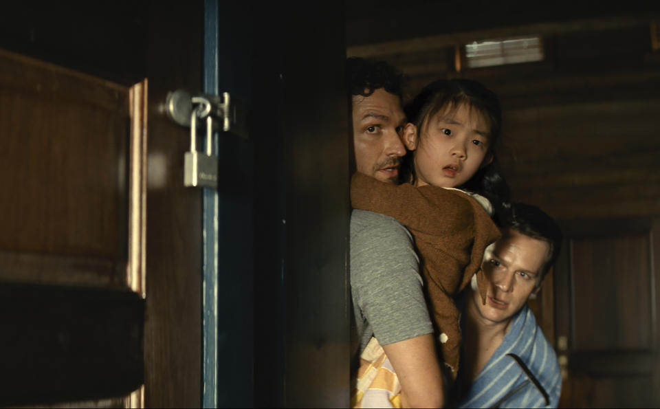 This image released by Universal Pictures shows Ben Aldridge, from left, Kristen Cui, and Jonathan Groff in a scene from "Knock at the Cabin." (Universal Pictures via AP)