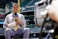 Los Angeles Dodgers television reporter David Vassegh works on a pregame broadcast before a baseball game against the Milwaukee Brewers Thursday, Aug. 18, 2022, in Milwaukee. Vassegh said he broke two bones in his right wrist and cracked six ribs Wednesday when he tumbled and crashed into the padding at the end of his slide down "Bernie's Chalet," where Brewers mascot Bernie Brewer takes up residence behind the American Family Field left-field stands. (AP Photo/Morry Gash)