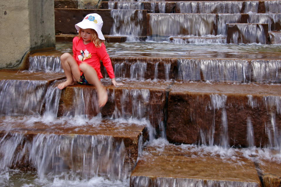 Cara Eshenbaugh, 4, of Pittsburgh, plays in a fountain on the Northside of Pittsburgh with the temperature hitting 90 degrees, Wednesday, Aug. 29, 2018. (AP Photo/Gene J. Puskar)