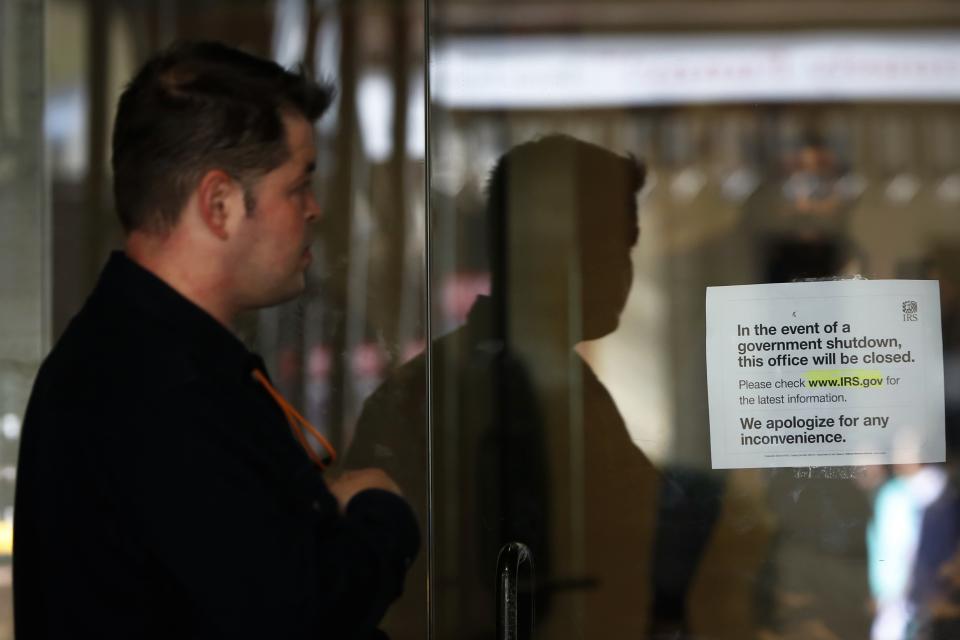 A man views a sign warning that the Internal Revenue Service building is closed at their offices in New York October 1, 2013. The U.S. government began a partial shutdown on Tuesday for the first time in 17 years, potentially putting up to 1 million workers on unpaid leave, closing national parks and stalling medical research projects. REUTERS/Shannon Stapleton (UNITED STATES - Tags: BUSINESS POLITICS)