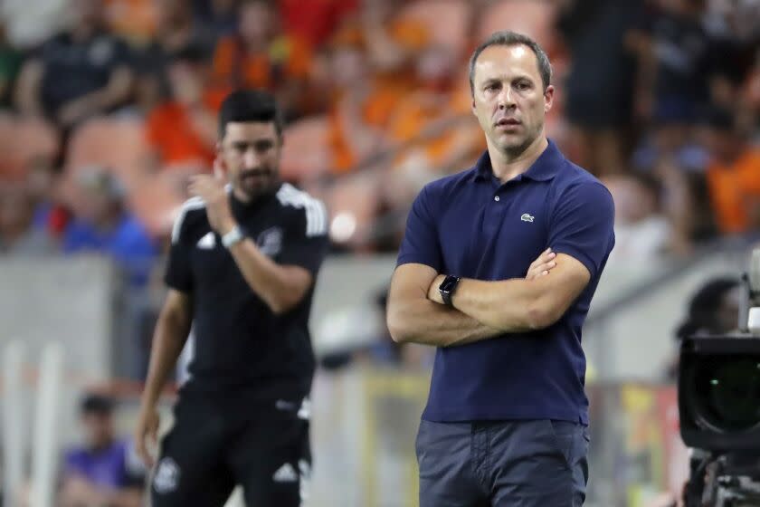 Los Angeles FC head coach Steve Cherundolo, right, and Houston Dynamo head coach Paulo Nagamura, left, watch play from the sidelines during the first half of an MLS soccer match Wednesday, August 31, 2022, in Houston. (AP Photo/Michael Wyke)