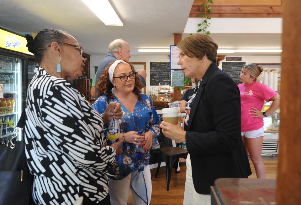 Amplify POC board chairwoman Jeanne Morrison, left, and Amplify POC founder and executive director Tara Vargas Wallace talk in June in Dennis with then-Attorney General Maura Healey.
