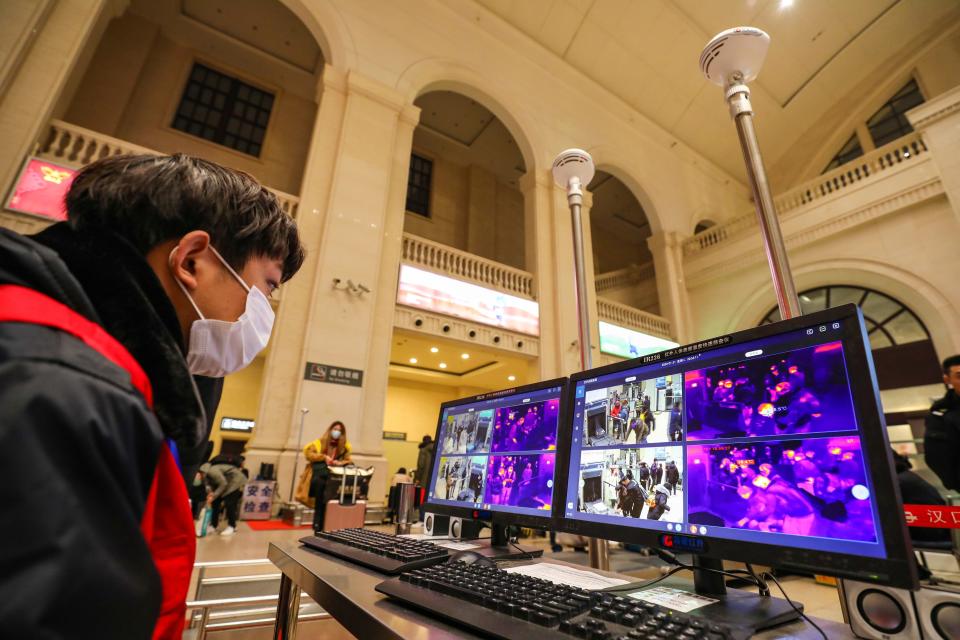 In this Tuesday, Jan. 21, 2020, photo, a worker monitors display screens for infrared thermometers as they check travelers at Hankou Railway Station in Wuhan in southern China's Hubei province. The U.S. on Tuesday reported its first case of a new and potentially deadly virus circulating in China, saying a Washington state resident who returned last week from the outbreak's epicenter was hospitalized near Seattle. (Chinatopix via AP)