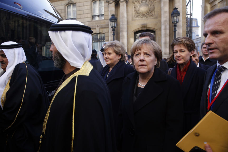 German Chancellor Angela Merkel, center, and Swiss President Simonetta Sommaruga, 2nd right, leave the Elysee Palace to join unity march. (AP Photo/Yoan Valat, Pool)