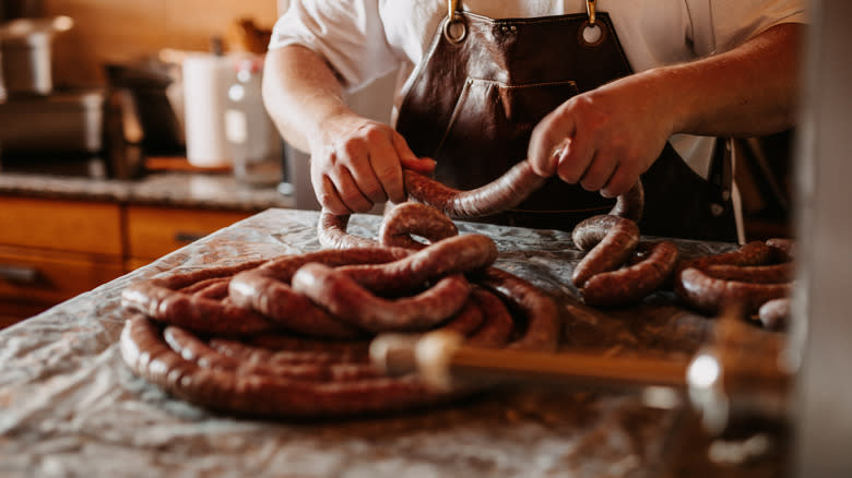 butcher making sausage links