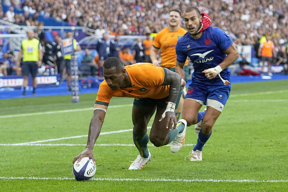 Australia's Suliasi Vunivalu scores a try during the International Rugby Union World Cup warm-up match between France and Australia at the Stade de France stadium in Saint Denis, outside Paris, Sunday, Aug. 27, 2023. (AP Photo/Michel Euler)