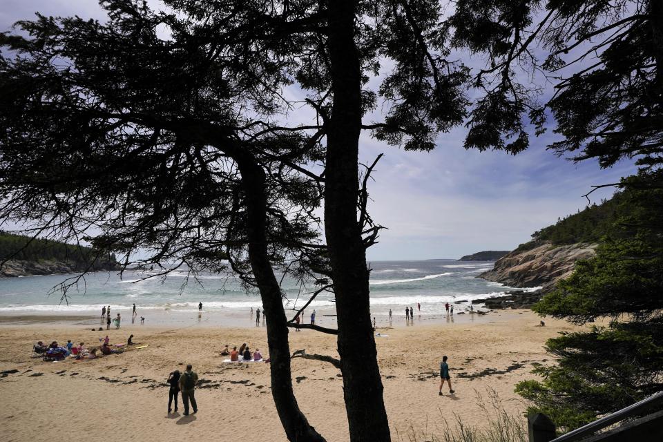 Beach-goers enjoy Sand Beach in Acadia National Park, Saturday, June 11, 2002, near Bar Harbor, Maine. The park will not have lifeguards on duty this summer due to worker and housing shortages. (AP Photo/Robert F. Bukaty)