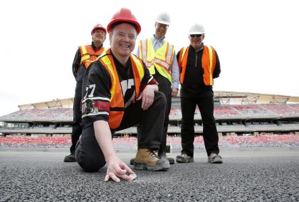 Scott Bradley, a lifelong Ottawa football fan, embeds a 1976 Canadian silver dollar in the asphalt at midfield at the new home of the Ottawa Redblacks CFL football team, TD Place at Lansdowne, with Gerry Organ, left, a player on the 76 Ottawa team, Ottawa Mayor Jim Watson, and Jeff Hunt, right, , president of the Ottawa Sports and Entertainment Group (OSEG), the owners of the new team, Thursday, May 29, 2014 in Ottawa. The last time an Ottawa team won the Grey Cup was in 1976. (AP Photo/The Canadian Press, Patrick Doyle)