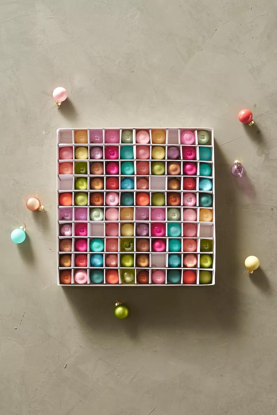 box with 100 different colored glass bulb ornaments