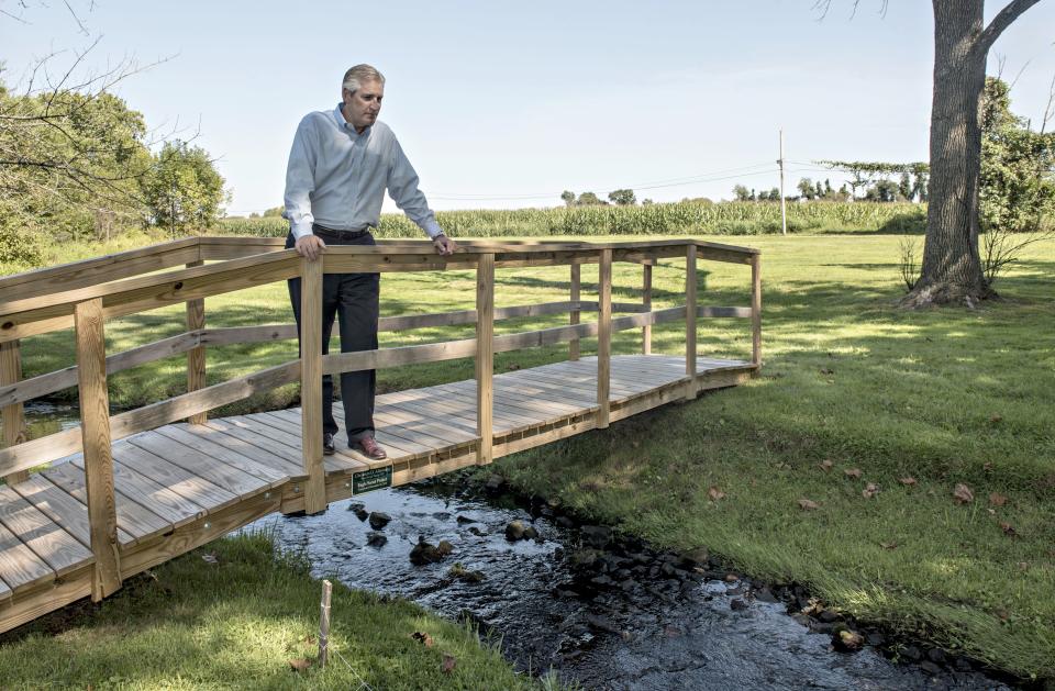 State Representative Todd Stephens looks over a waterway running through Graeme Park in Horsham. Stephens has been a vocal critic of the military's efforts to clean up contamination from firefighting chemicals that have entered drinking water from area military bases. [KIM WEIMER / PHOTOJOURNALIST]