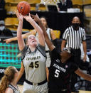 Stanford forward Francesca Belibi, right, blocks a shot by Colorado forward Charlotte Whittaker in the first half of an NCAA college basketball game Sunday, Jan. 17, 2021, in Boulder, Colo. (AP Photo/David Zalubowski)