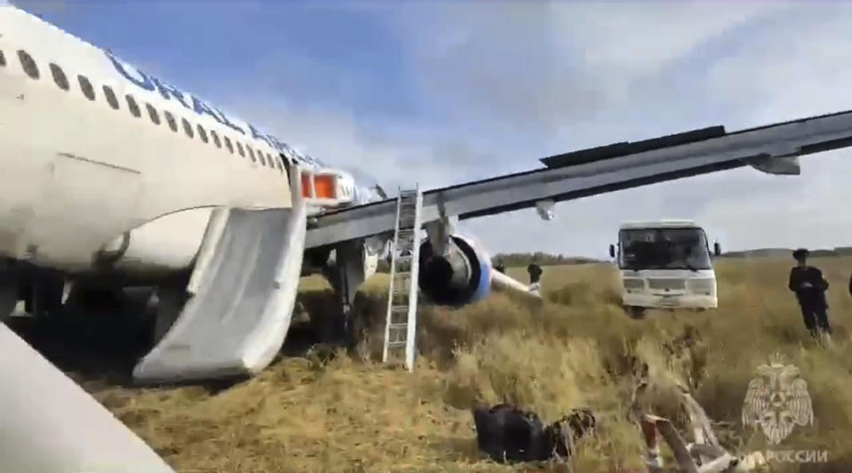 In this image made from video provided by Russian Emergency Situations Ministry press service, an Airbus A320 of Ural Airlines is seen after emergency landing near Ubinskoye village, Novosibirsk Region, Russia, Tuesday, Sept. 12, 2023. An Airbus A320 with 161 passengers onboard has performed an emergency landing in a field in the Novosibirsk Region, according to Ural Airlines, TASS reported. (Ministry of Emergency Situations press service via AP)