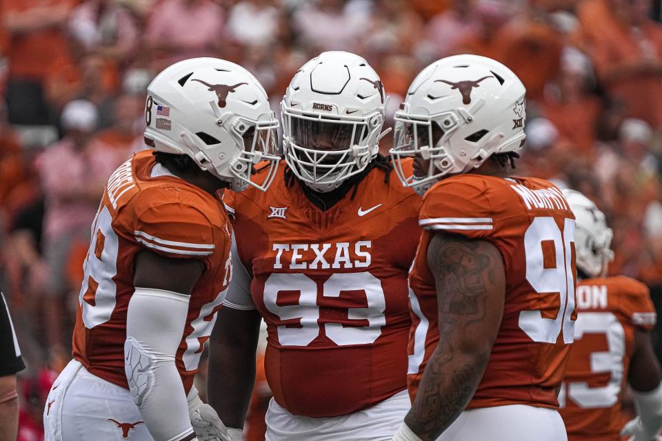 Texas defensive lineman T'Vondre Sweat (93), center, huddles with teammates during the game against Kansas State at Royal-Memorial Stadium on Saturday, Nov. 4, 2023 in Austin.