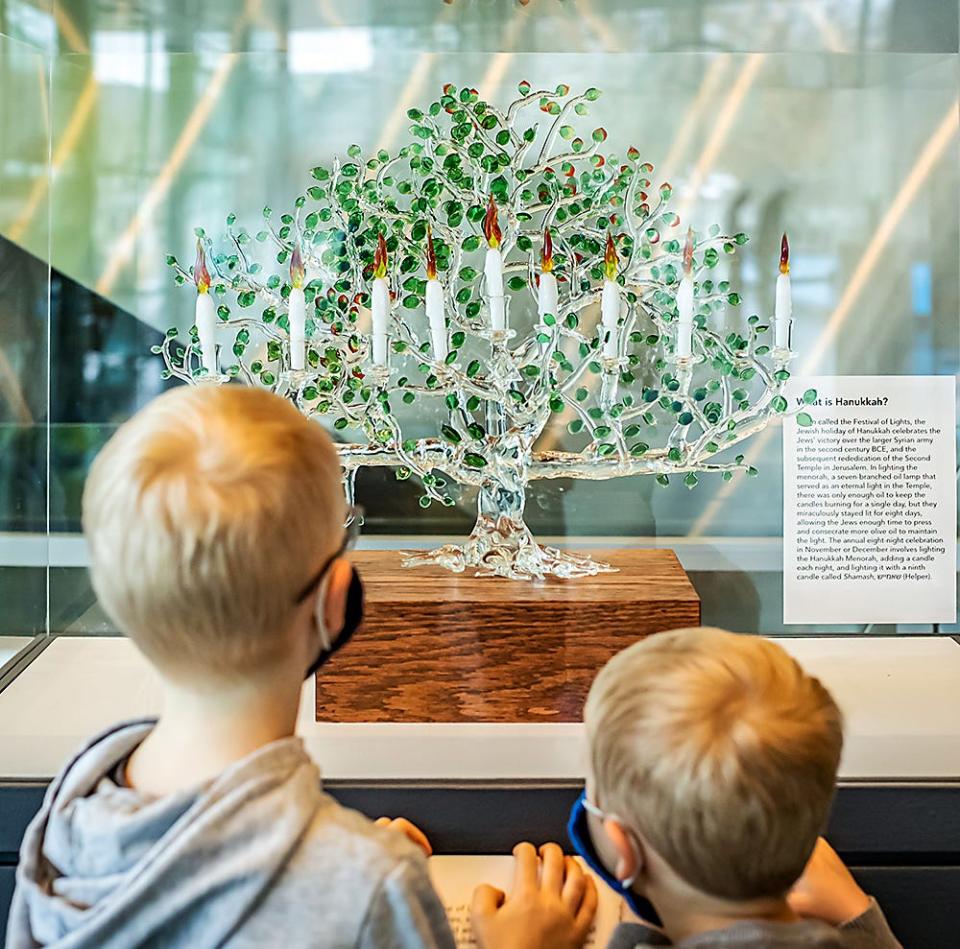 Siggy Meek, 6, and Lane Meek, 4, check out the newly-created Tree of Life Menorah, in celebration of Hanukkah, at the Corning Museum of Glass.